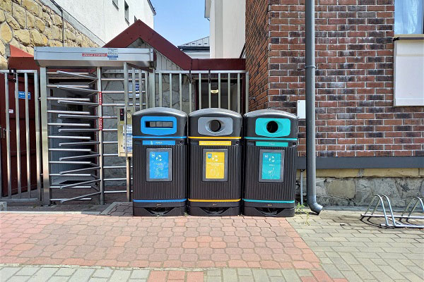 Three Jubilee waste bins with coloured apertures